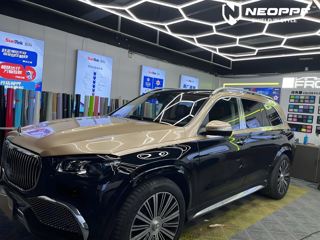 A sports car with Champagne Gold paint protection film colored wrap is parking in the garage