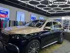 A sports car with Champagne Gold paint protection film colored wrap is parking in the garage