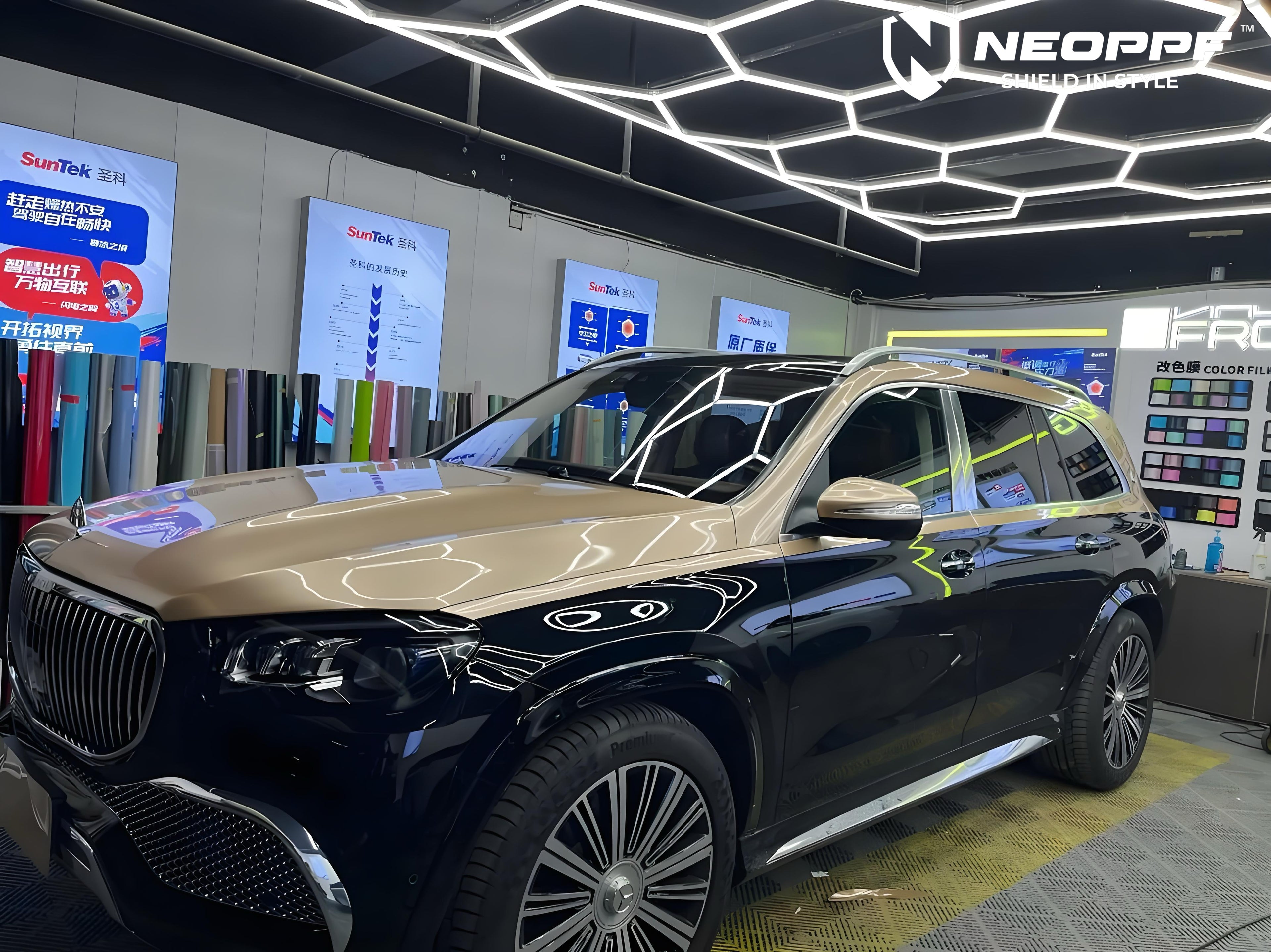 A sports car with Champagne Gold paint protection film colored wrap is parking in the garage