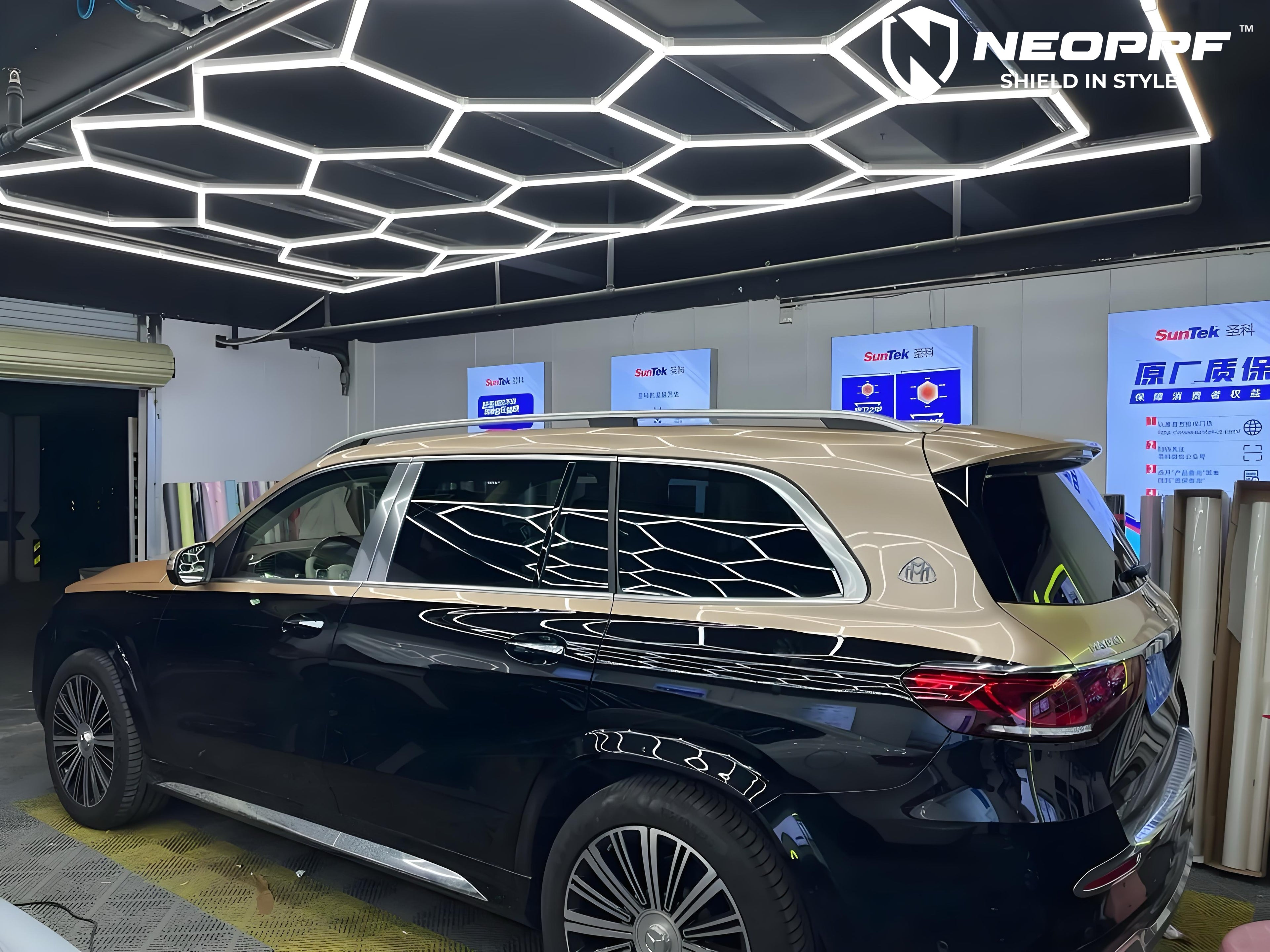 A sports car with Champagne Gold paint protection film colored wrap is parking in the garage