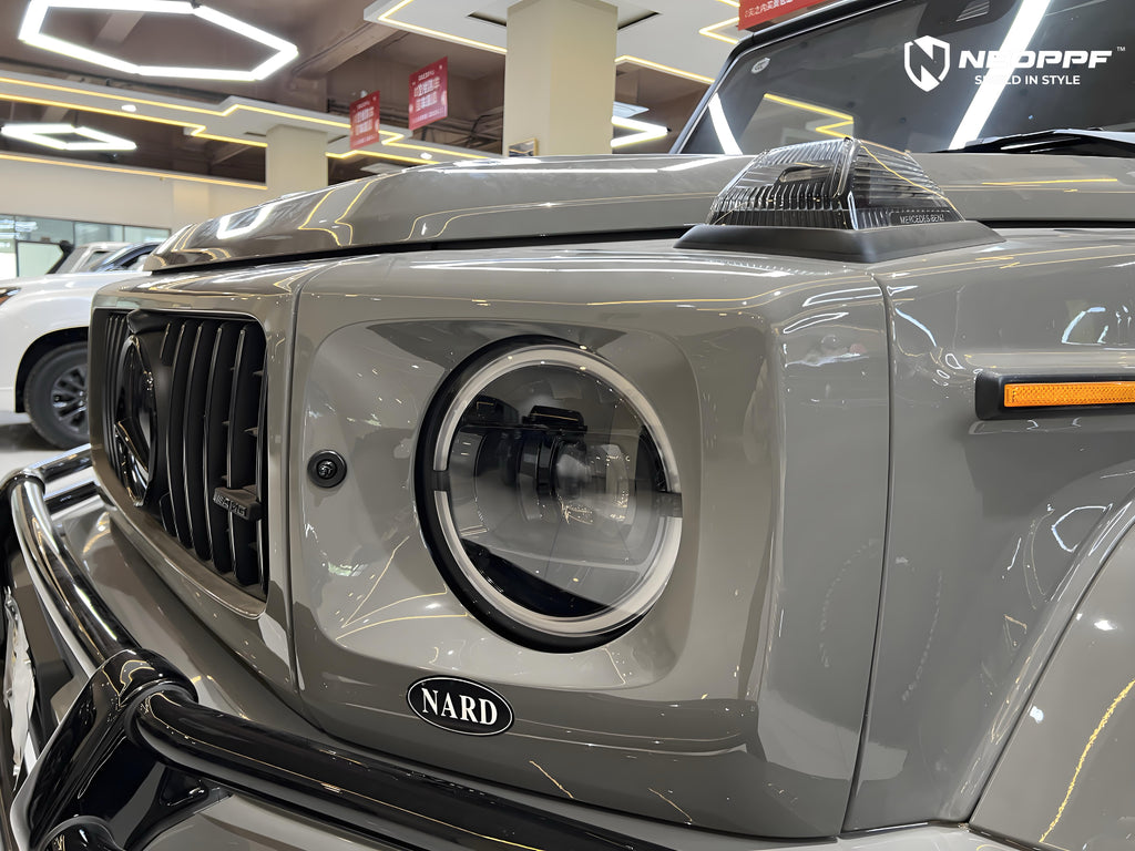 A sports car with Arabian Gray paint protection film colored wrap is parking in the garage
