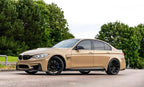 A sports car with Desert Storm paint protection film colored wrap is parking in the garage