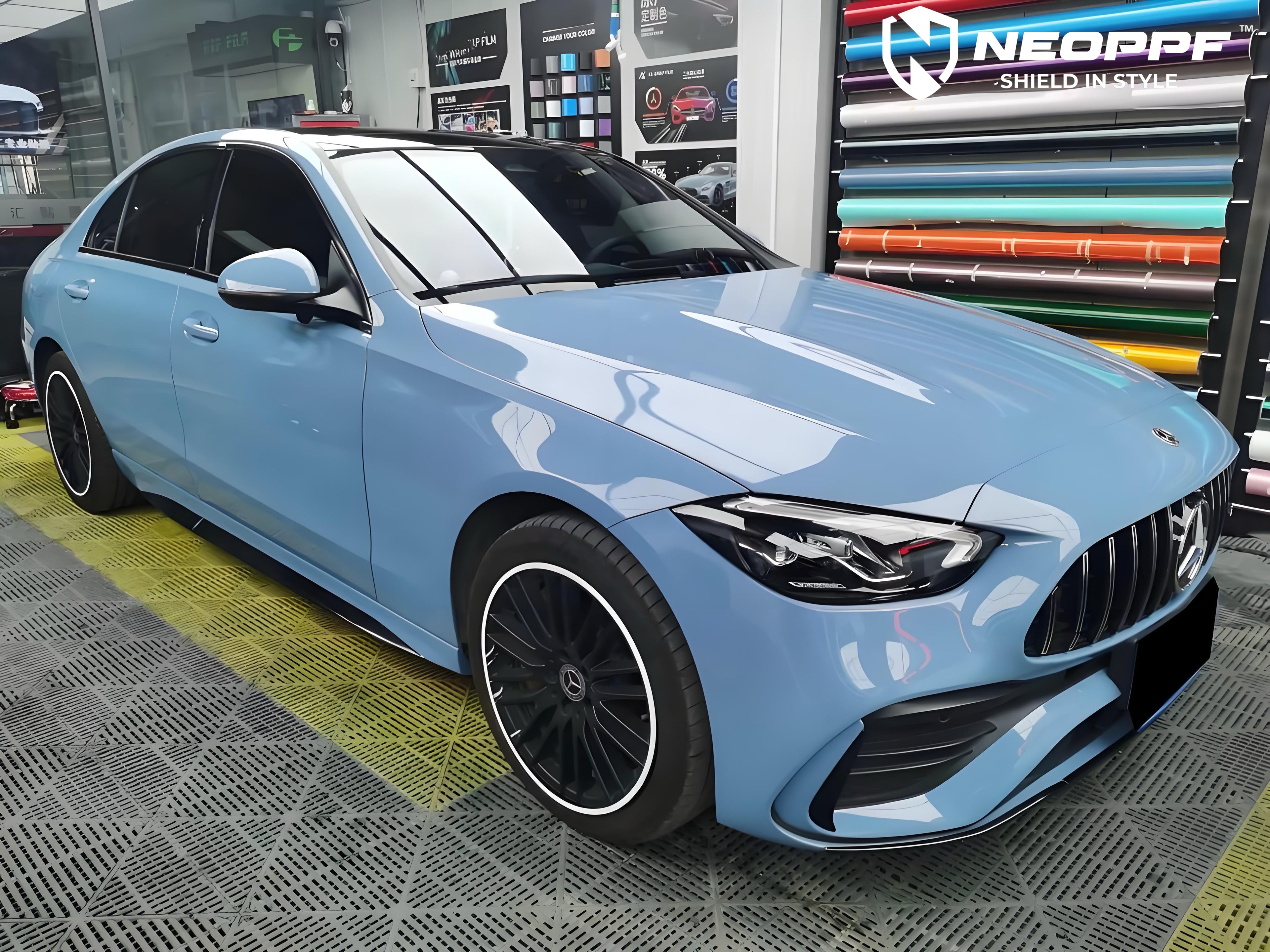 A sports car with Porcelain Blue paint protection film colored wrap is parking in the garage