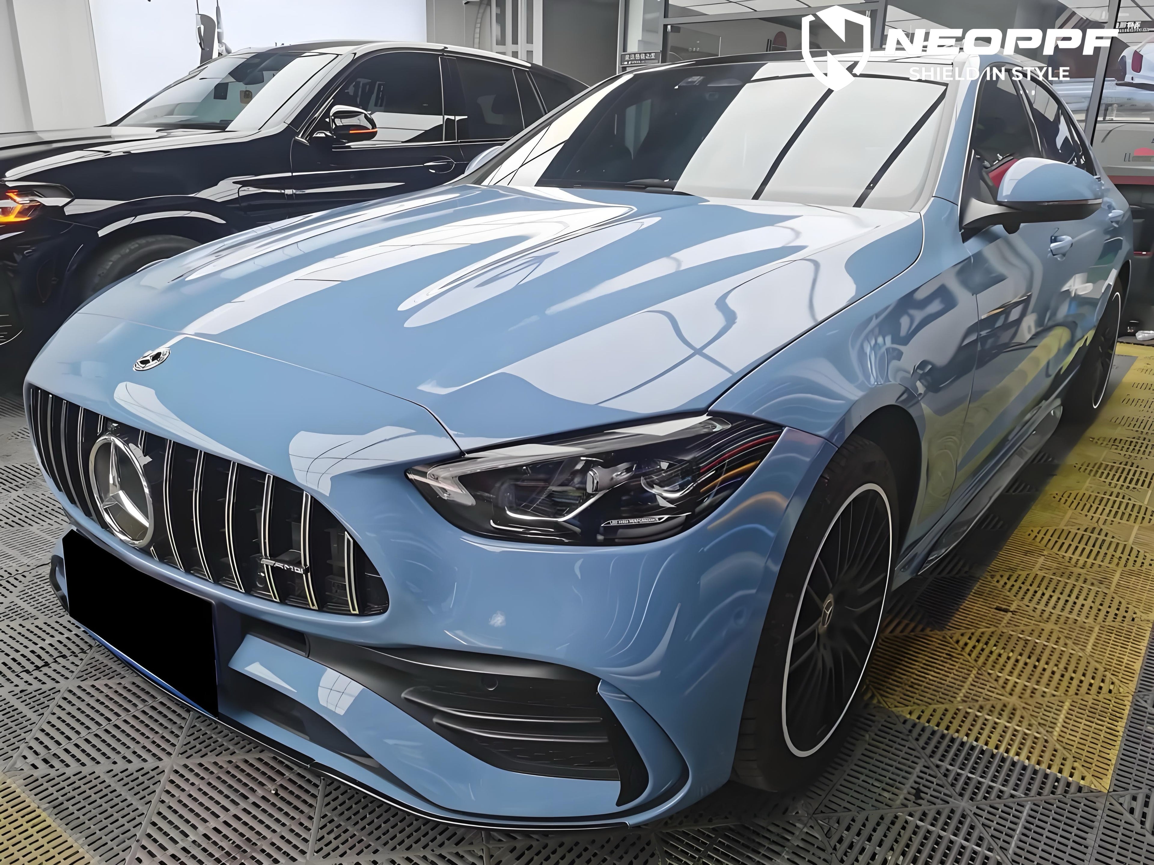 A sports car with Porcelain Blue paint protection film colored wrap is parking in the garage