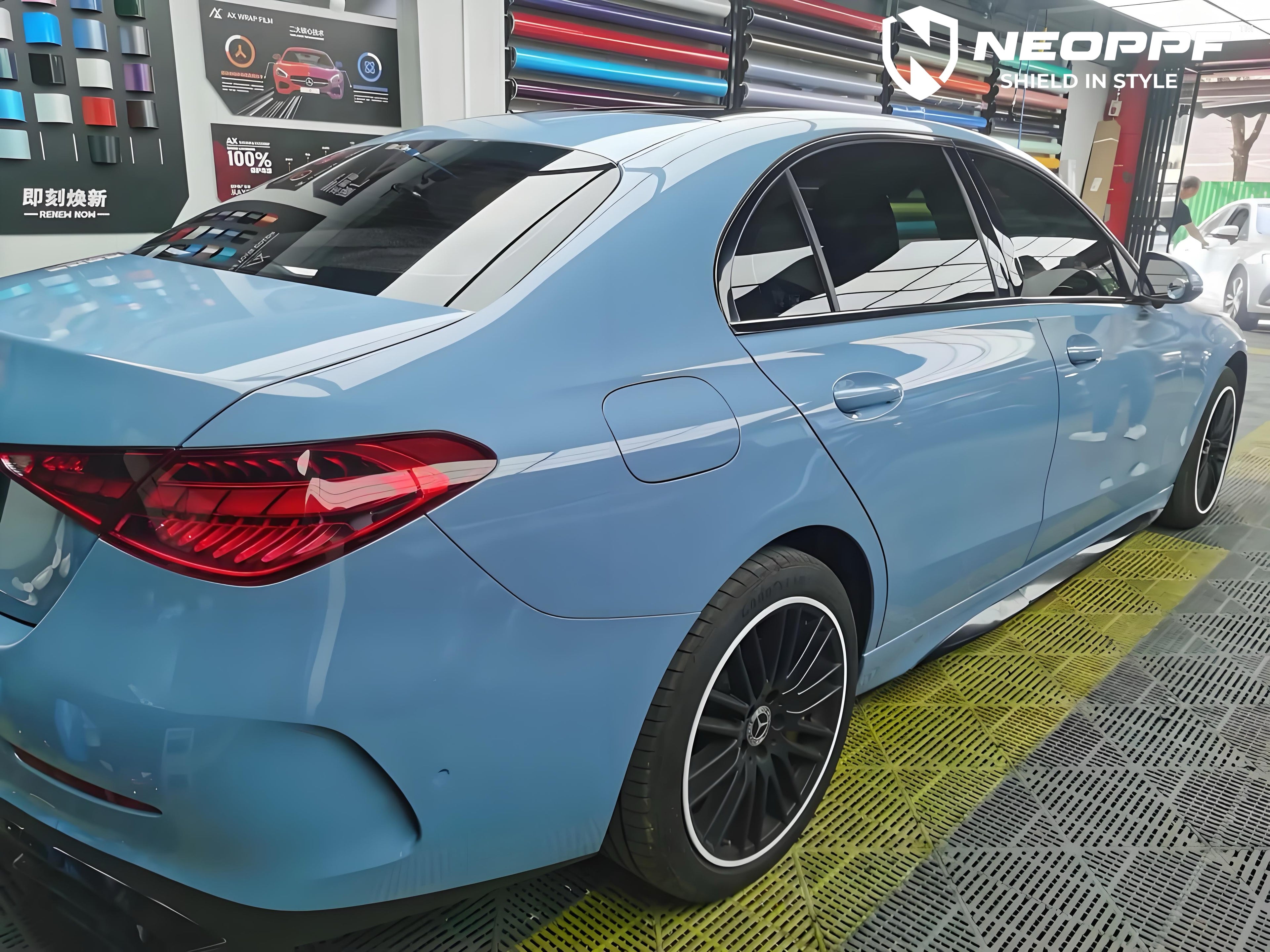 A sports car with Porcelain Blue paint protection film colored wrap is parking in the garage