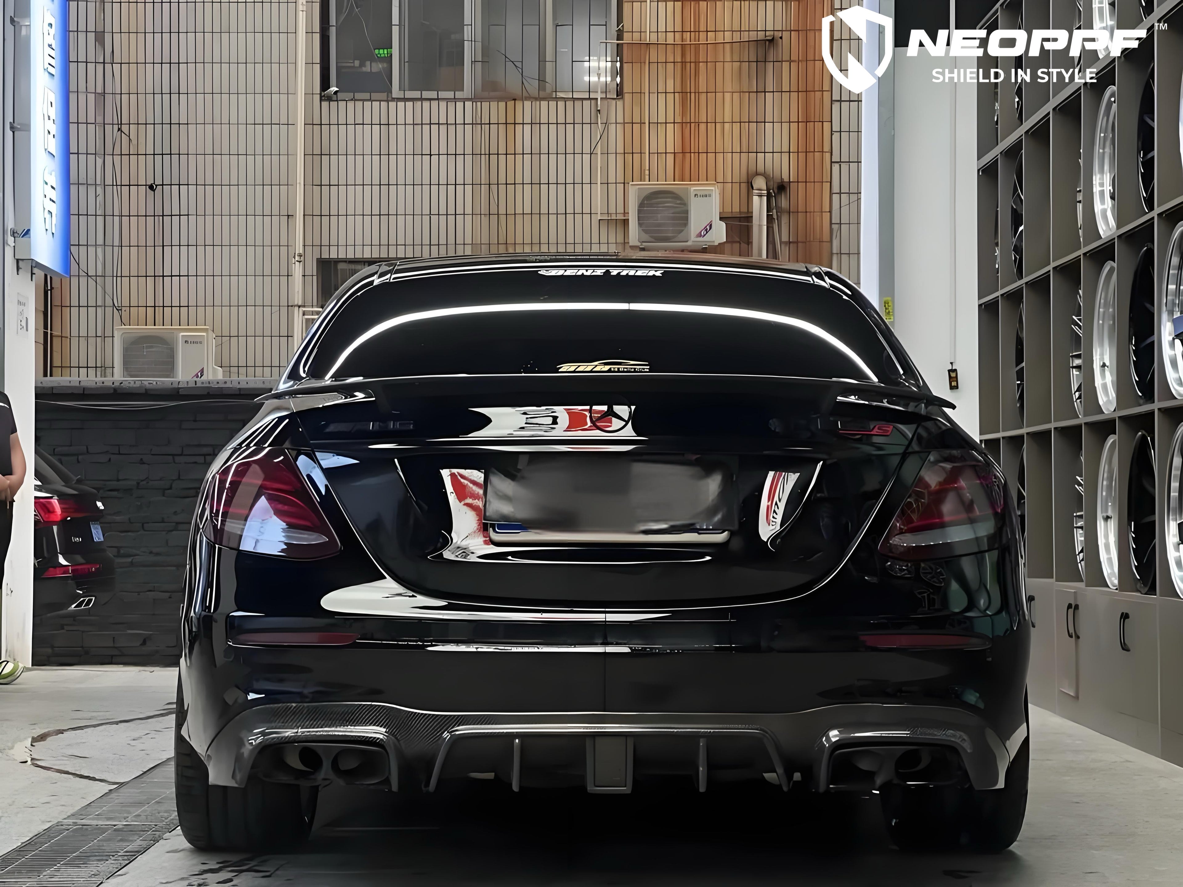 A sports car with Super Black paint protection film colored wrap is parking in the garage