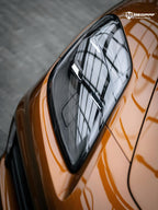 A sports car with Liquid Metallic Madeira Gold paint protection film colored wrap is parking in the garage