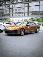 A sports car with Liquid Metallic Madeira Gold paint protection film colored wrap is parking in the garage