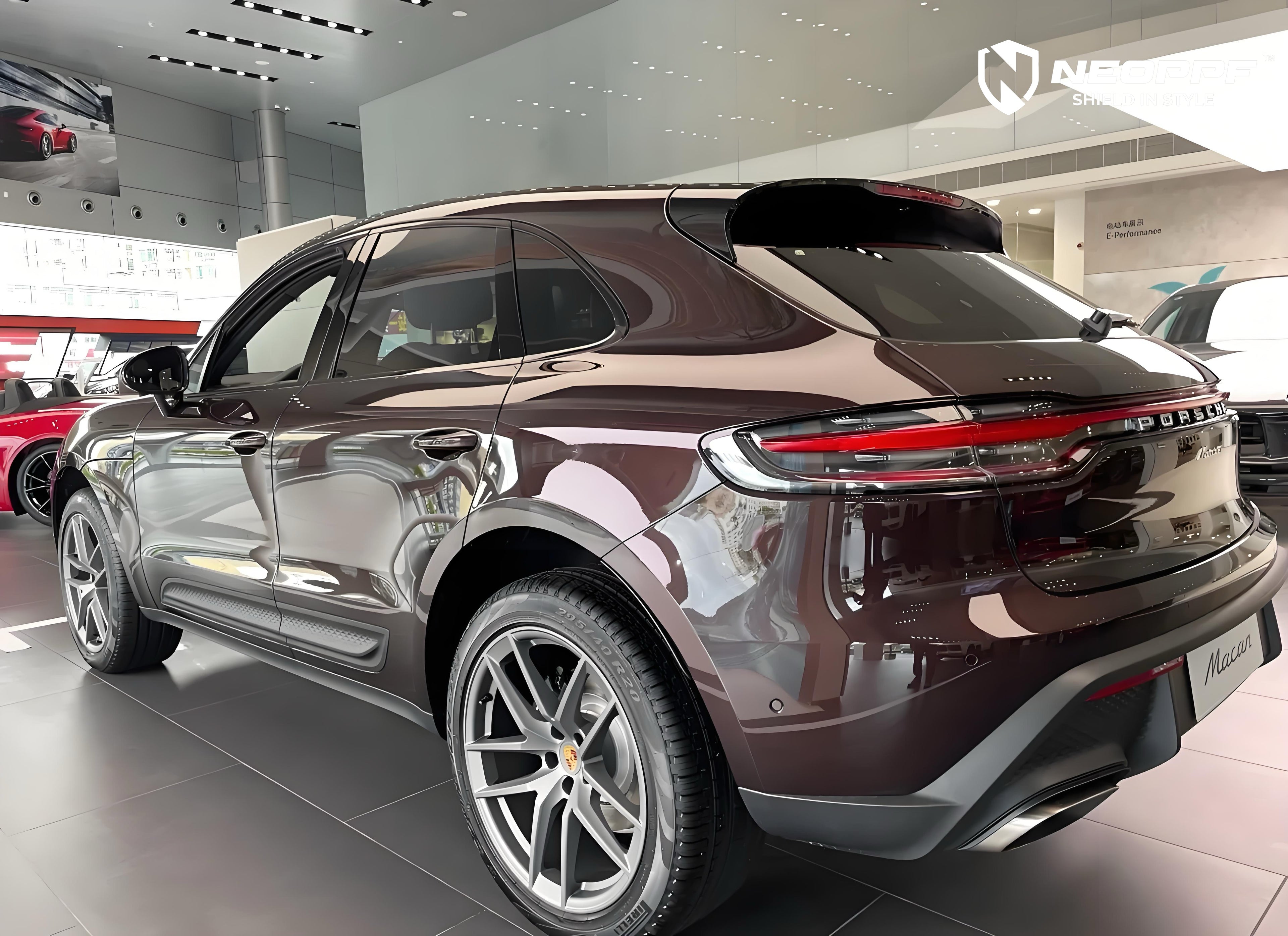A sports car with Peach Rosewood paint protection film colored wrap is parking in the garage