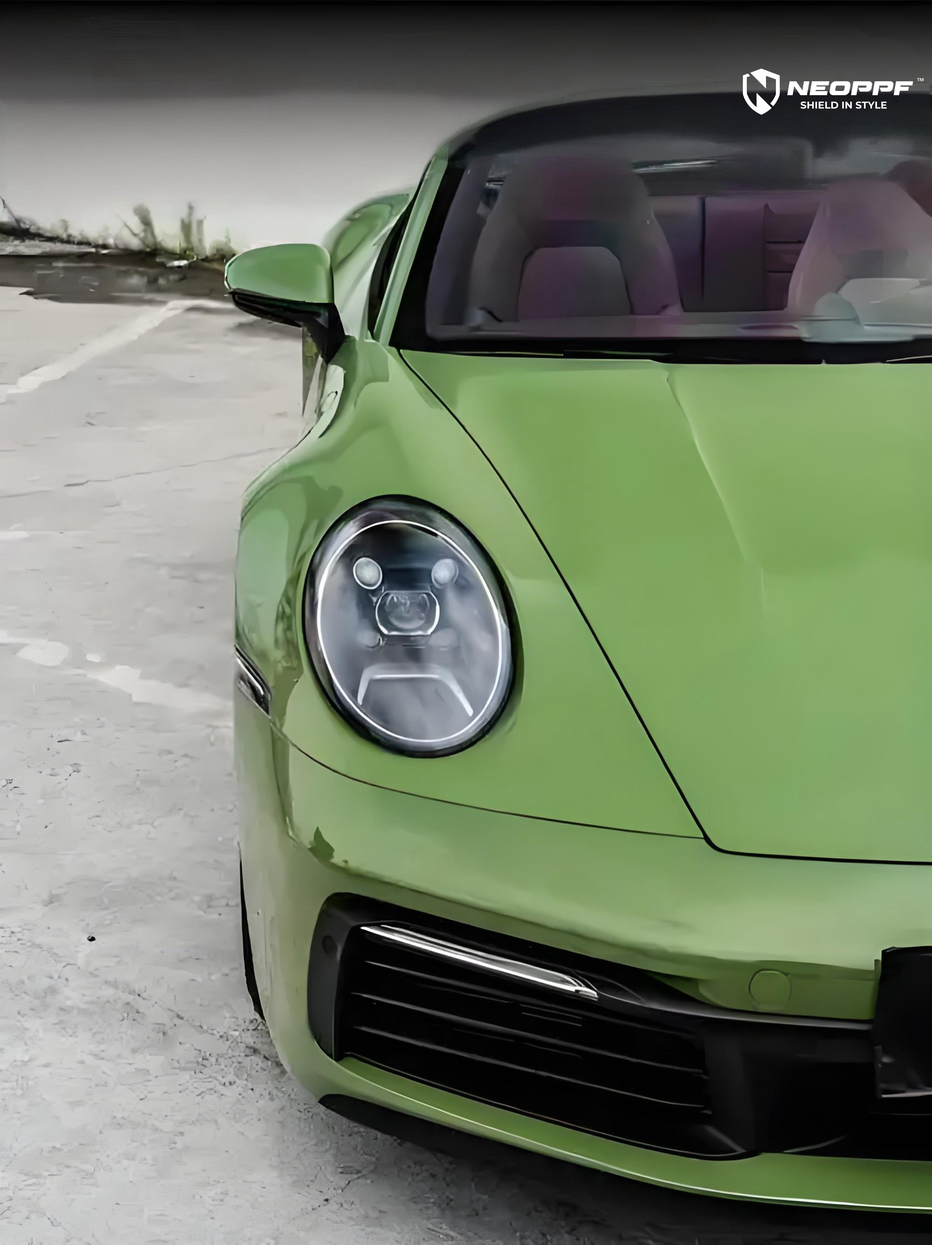 A sports car with Olive Green paint protection film colored wrap is parking in the garage