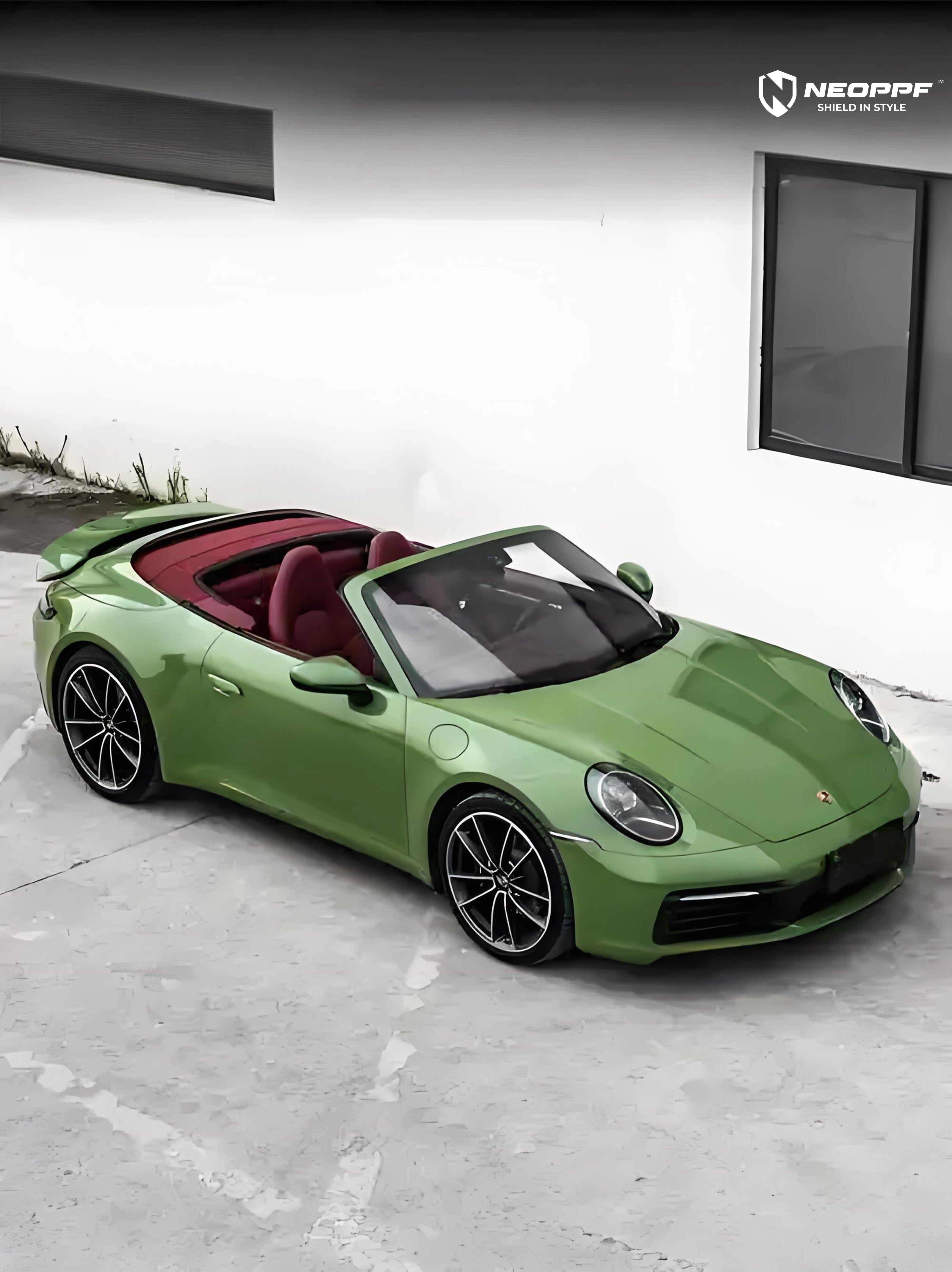 A sports car with Olive Green paint protection film colored wrap is parking in the garage