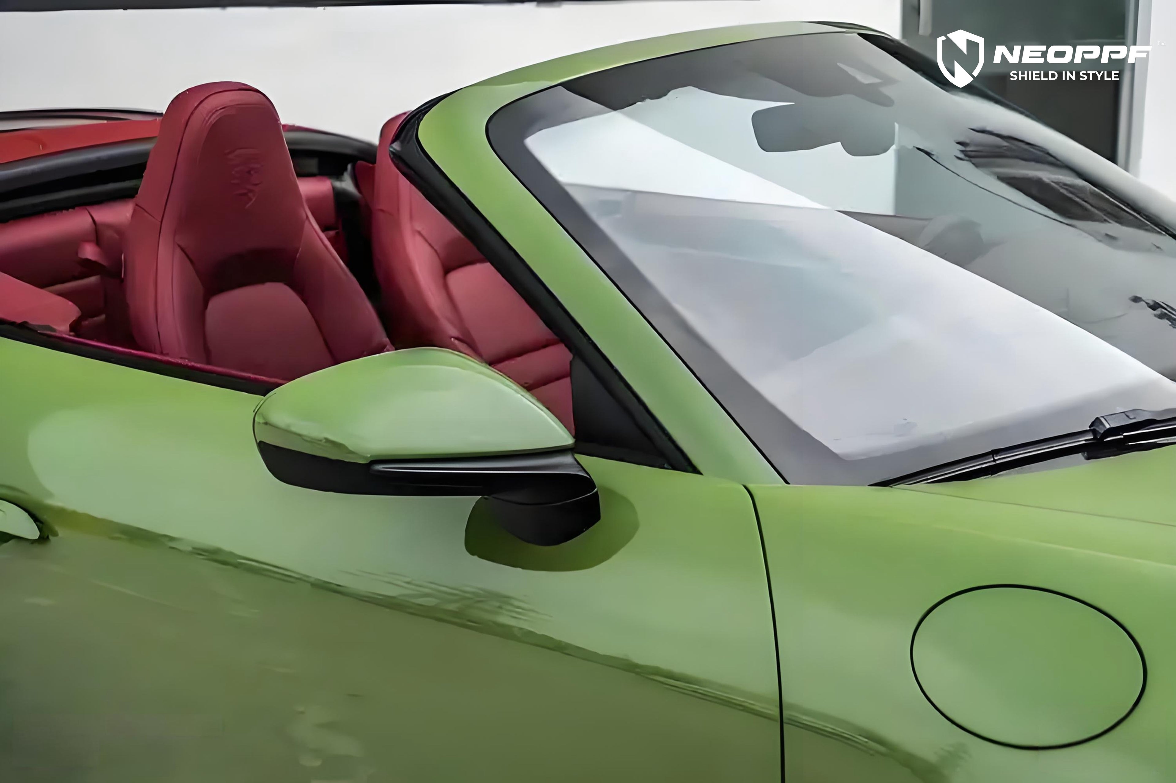 A sports car with Olive Green paint protection film colored wrap is parking in the garage