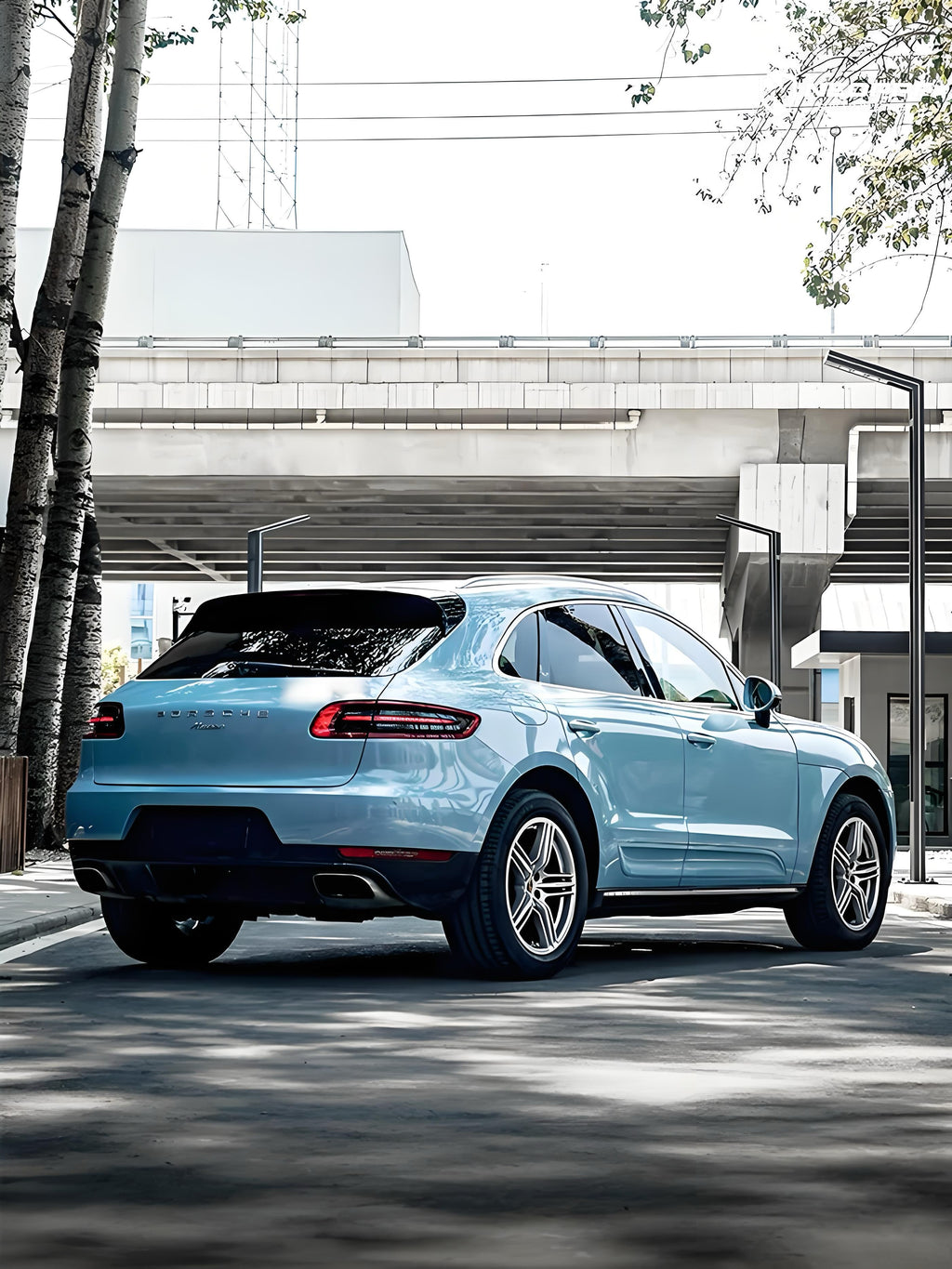 A sports car with Glacier Blue Metallic paint protection film colored wrap is parking in the garage