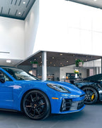 A sports car with Lugano Blue paint protection film colored wrap is parking in the garage