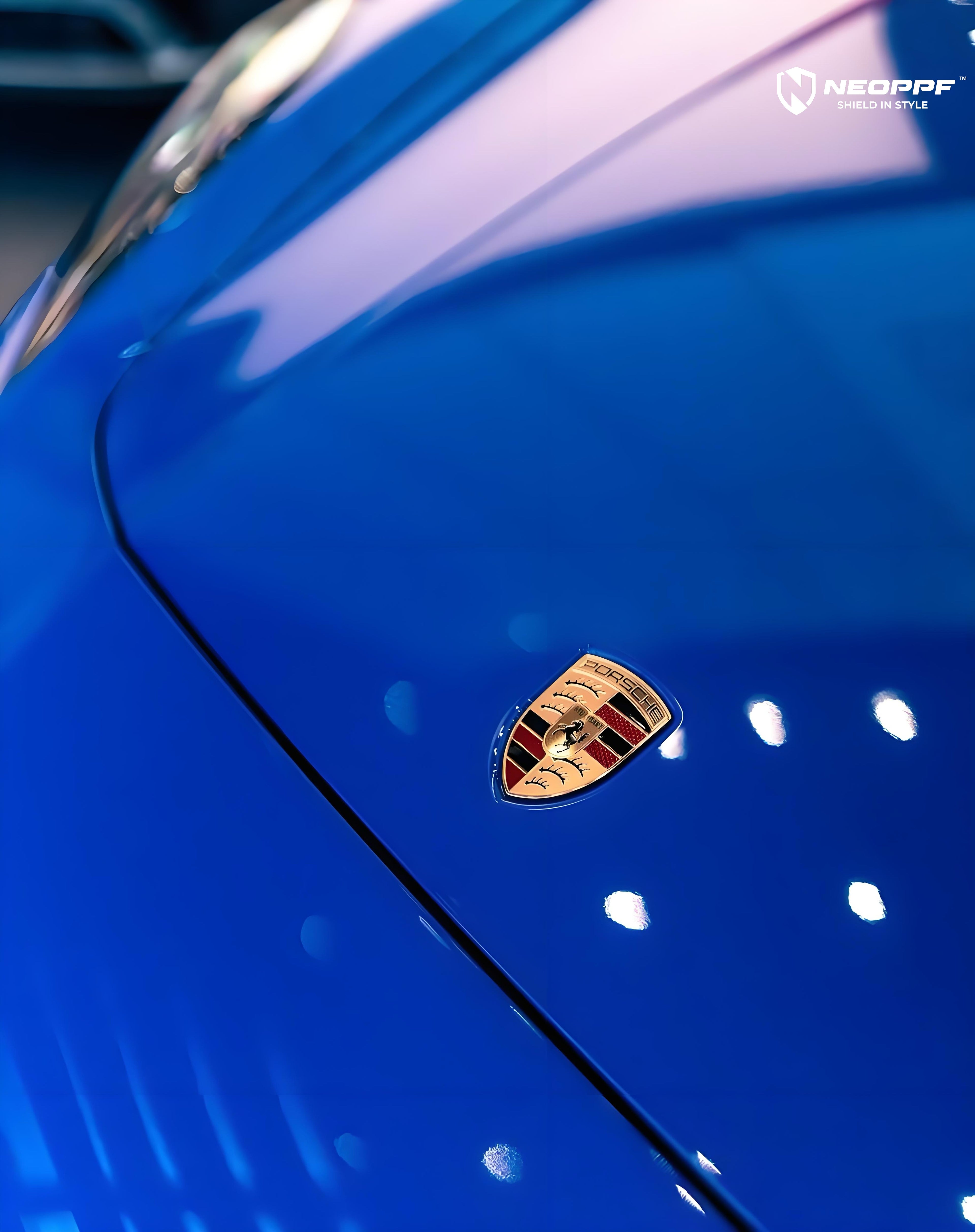 A sports car with Lugano Blue paint protection film colored wrap is parking in the garage