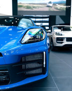 A sports car with Lugano Blue paint protection film colored wrap is parking in the garage