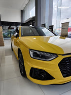 A sports car with Signal Yellow paint protection film colored wrap is parking in the garage