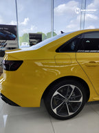 A sports car with Signal Yellow paint protection film colored wrap is parking in the garage