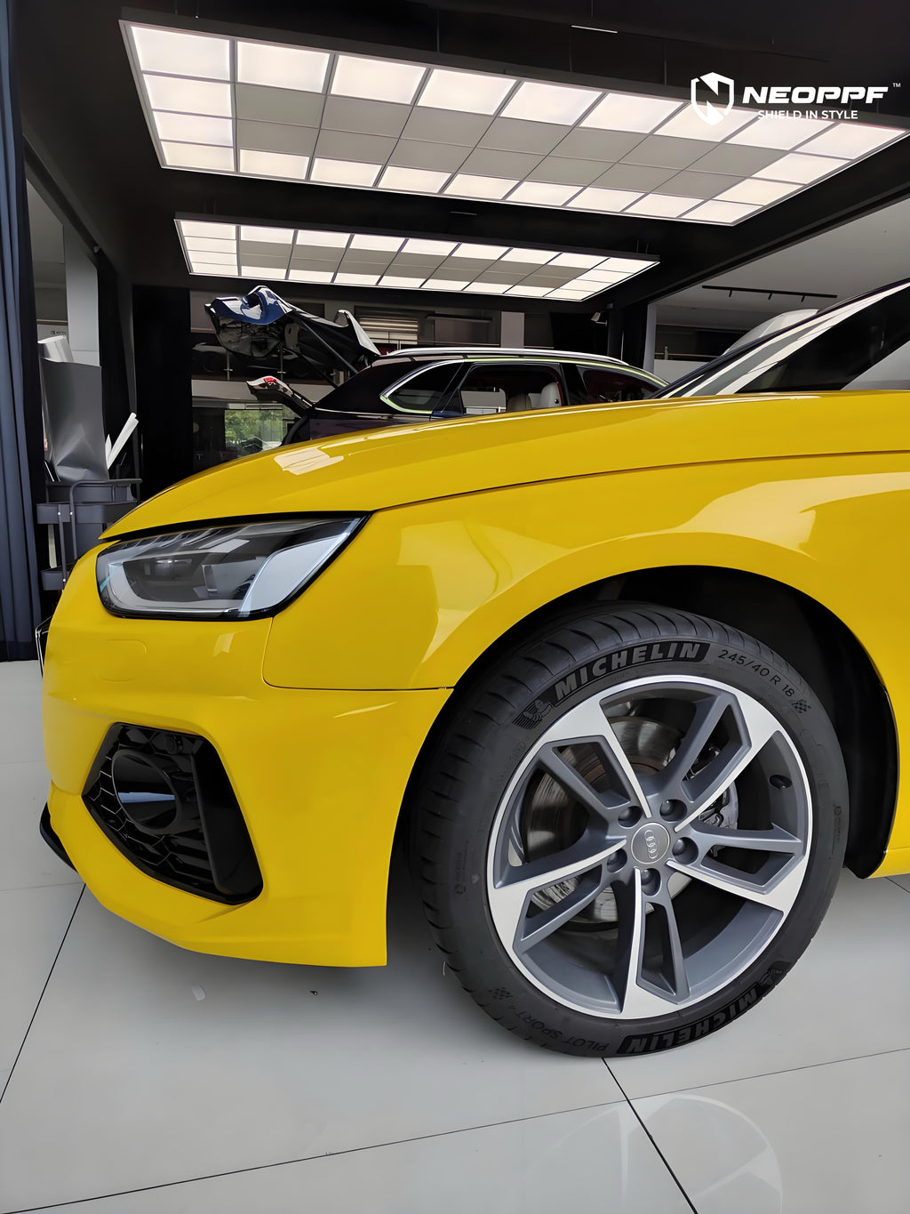 A sports car with Signal Yellow paint protection film colored wrap is parking in the garage
