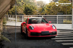A sports car with Strawberry Red paint protection film colored wrap is parking in the garage
