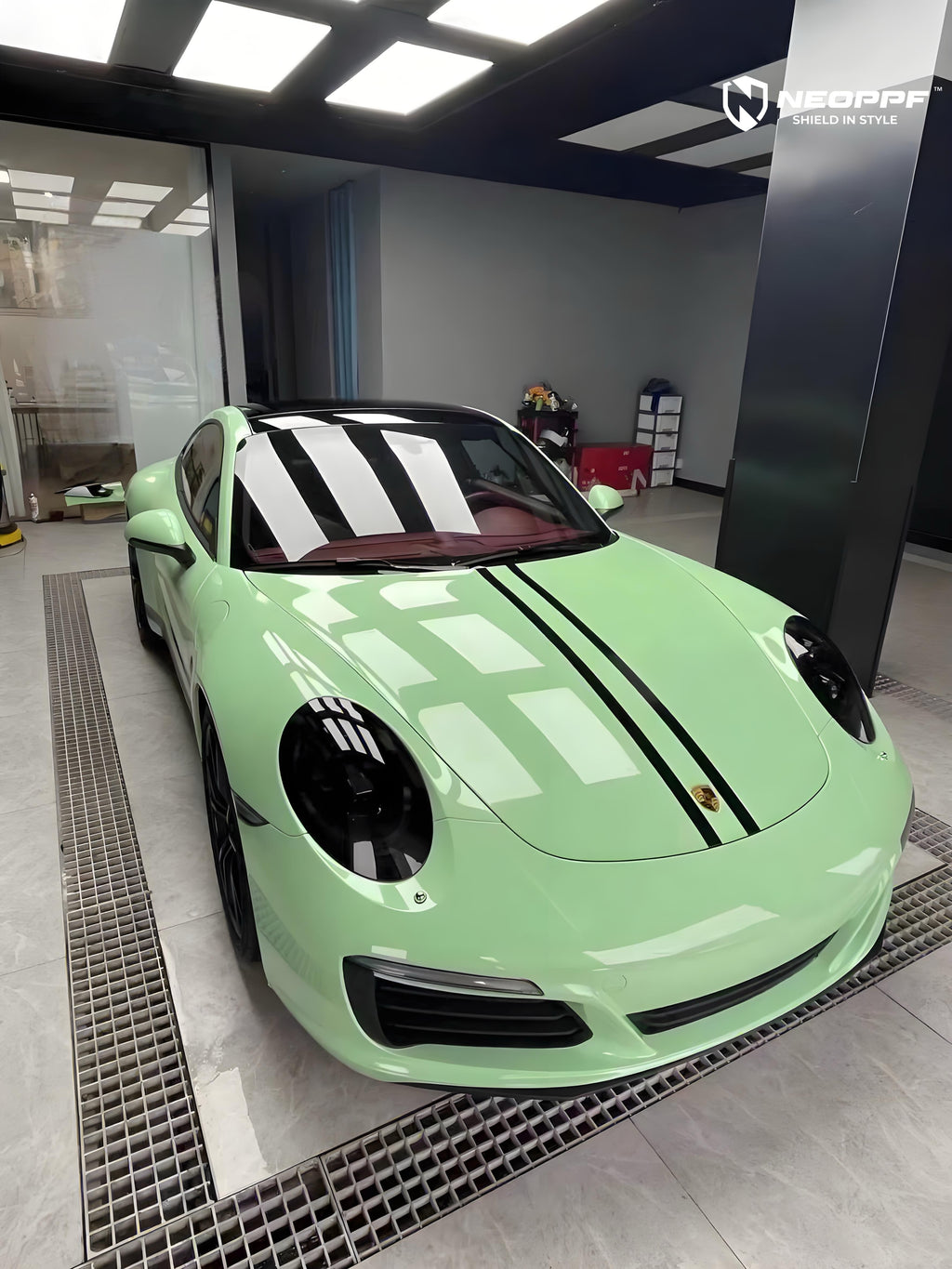 A sports car with Grayish Green paint protection film colored wrap is parking in the garage
