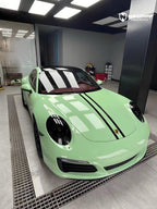 A sports car with Grayish Green paint protection film colored wrap is parking in the garage