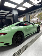 A sports car with Grayish Green paint protection film colored wrap is parking in the garage