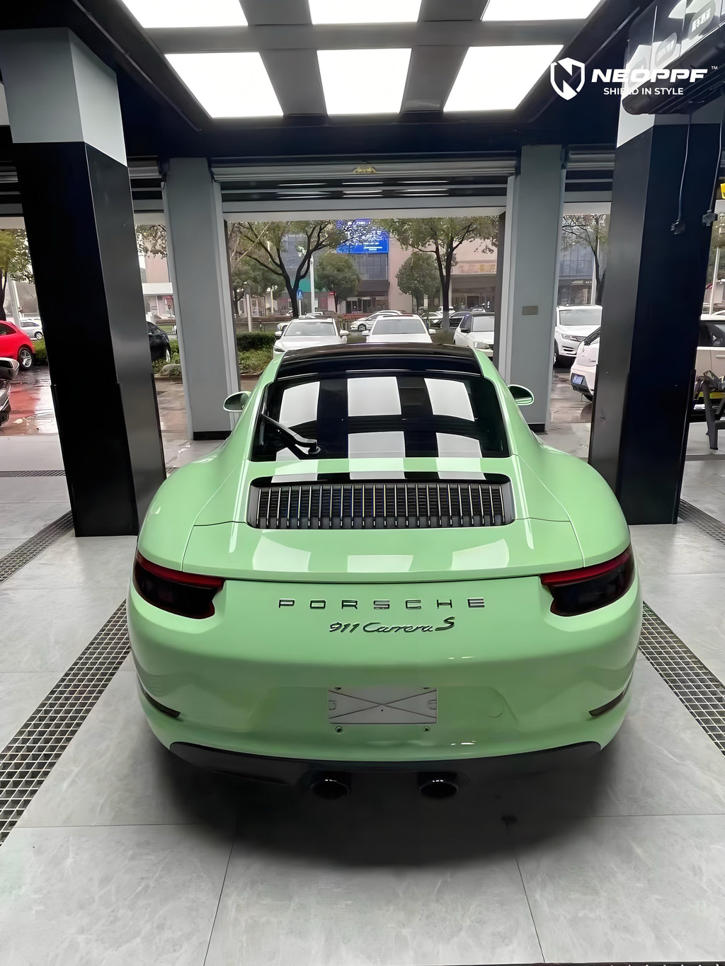 A sports car with Grayish Green paint protection film colored wrap is parking in the garage