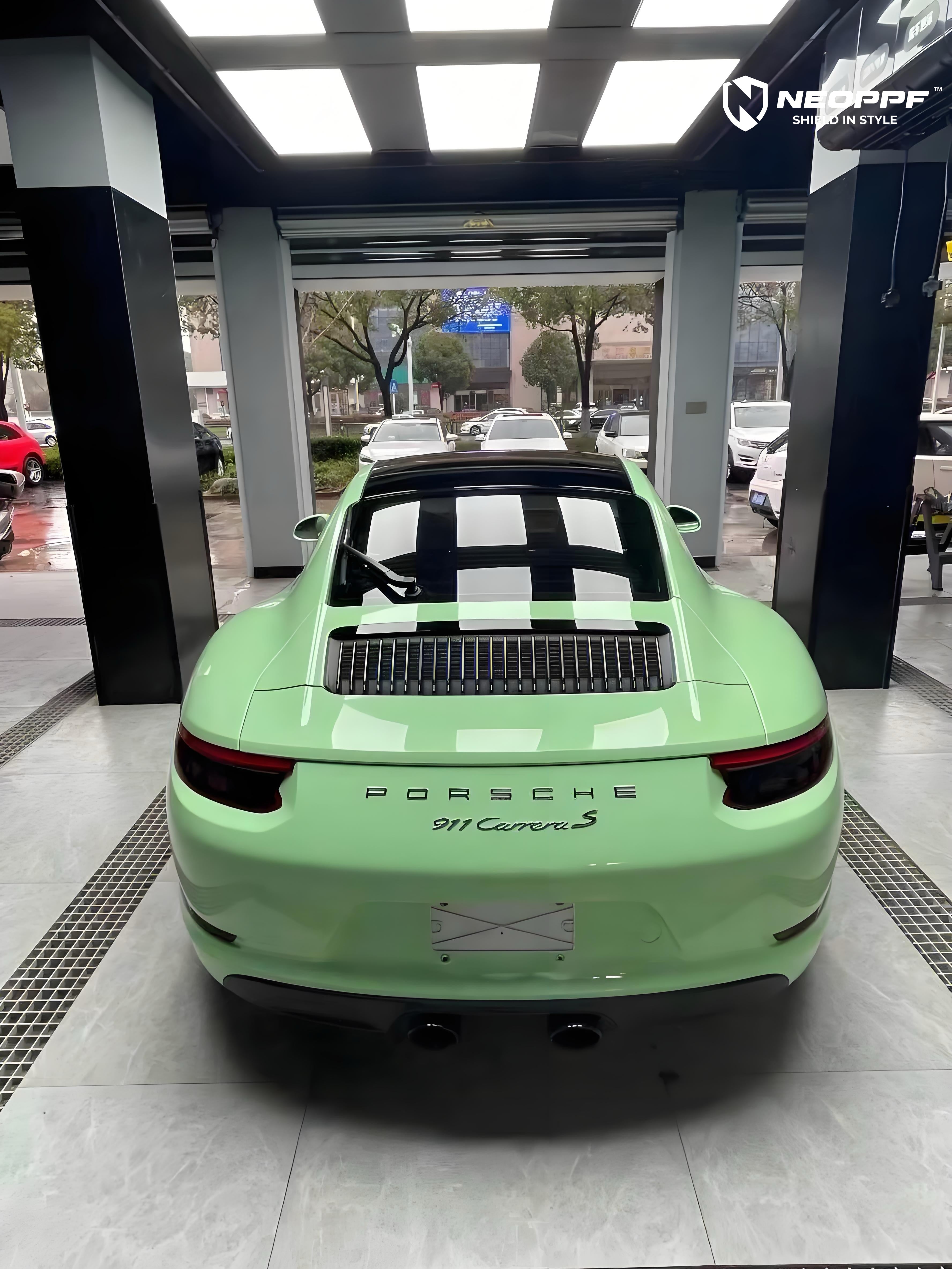 A sports car with Grayish Green paint protection film colored wrap is parking in the garage