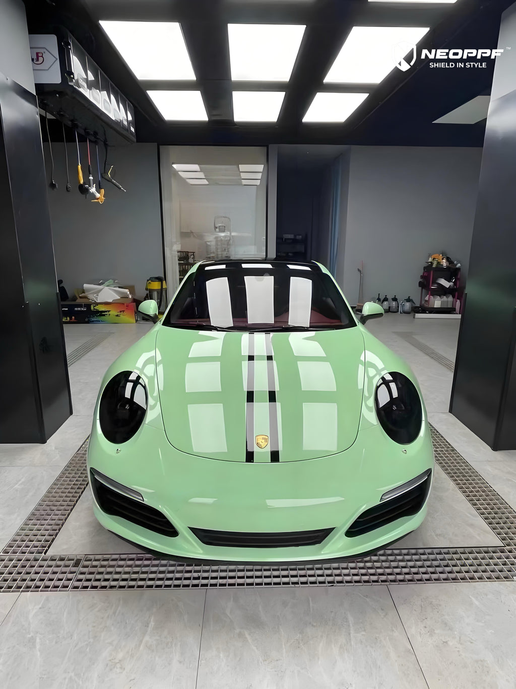 A sports car with Grayish Green paint protection film colored wrap is parking in the garage