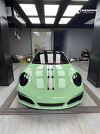 A sports car with Grayish Green paint protection film colored wrap is parking in the garage