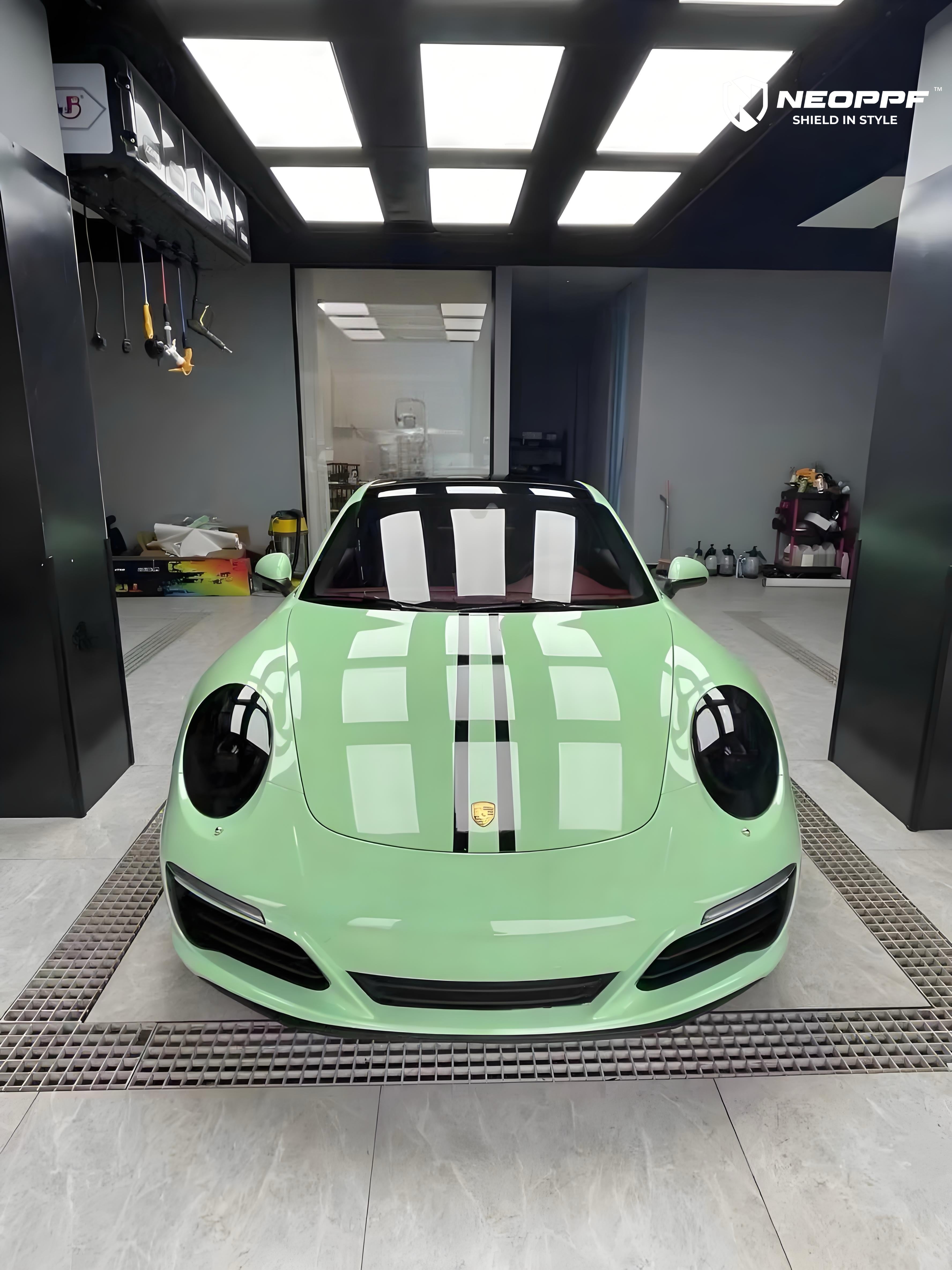 A sports car with Grayish Green paint protection film colored wrap is parking in the garage
