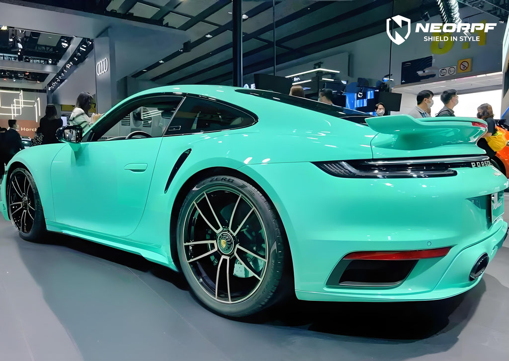 A sports car with Mint Green paint protection film colored wrap is parking in the garage