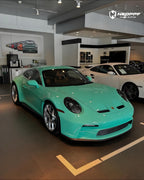 A sports car with Mint Green paint protection film colored wrap is parking in the garage