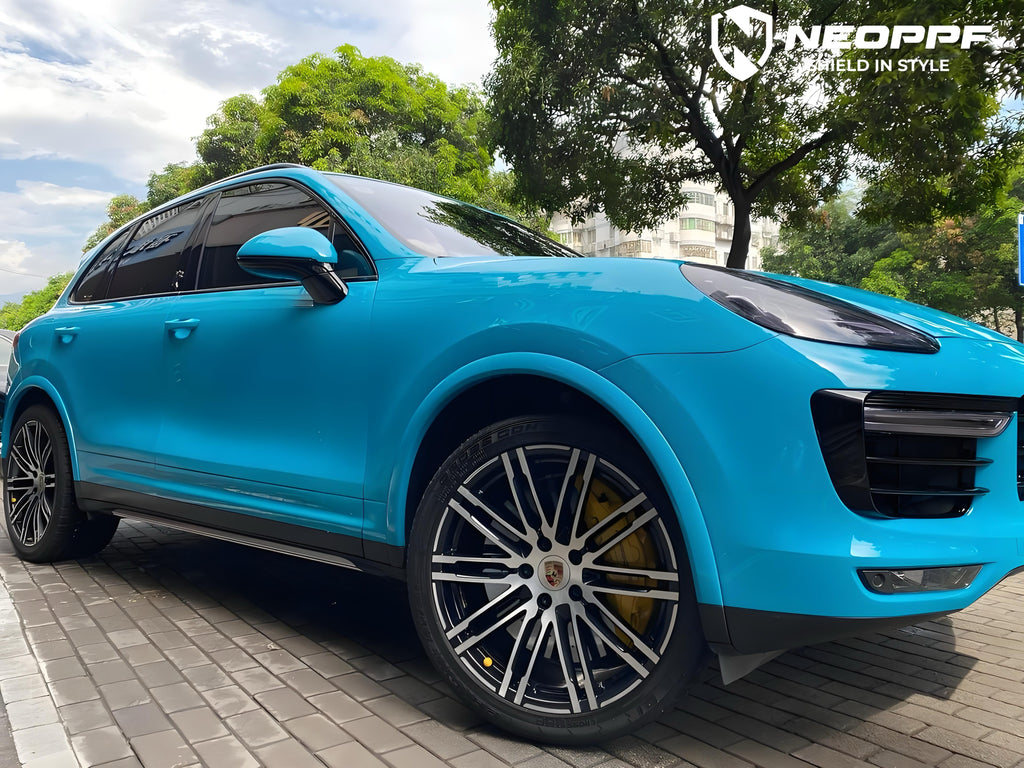 A sports car with Miami Blue paint protection film colored wrap is parking in the garage