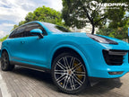 A sports car with Miami Blue paint protection film colored wrap is parking in the garage