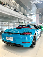 A sports car with Miami Blue paint protection film colored wrap is parking in the garage