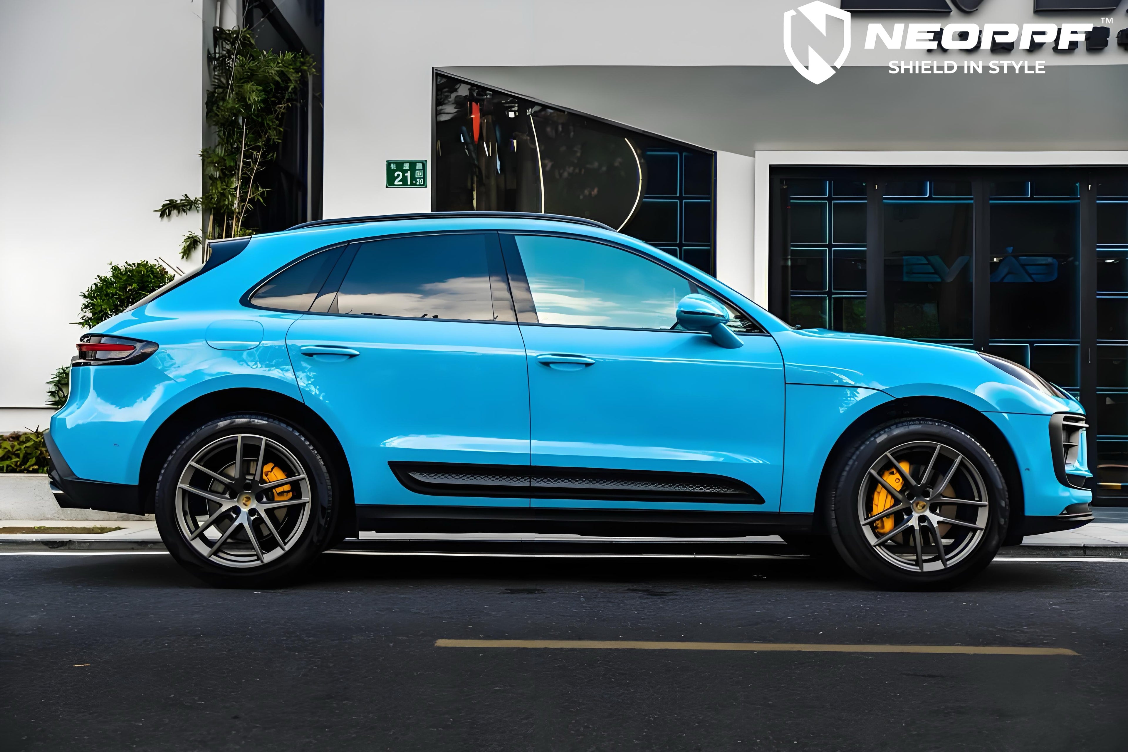 A sports car with Miami Blue paint protection film colored wrap is parking in the garage