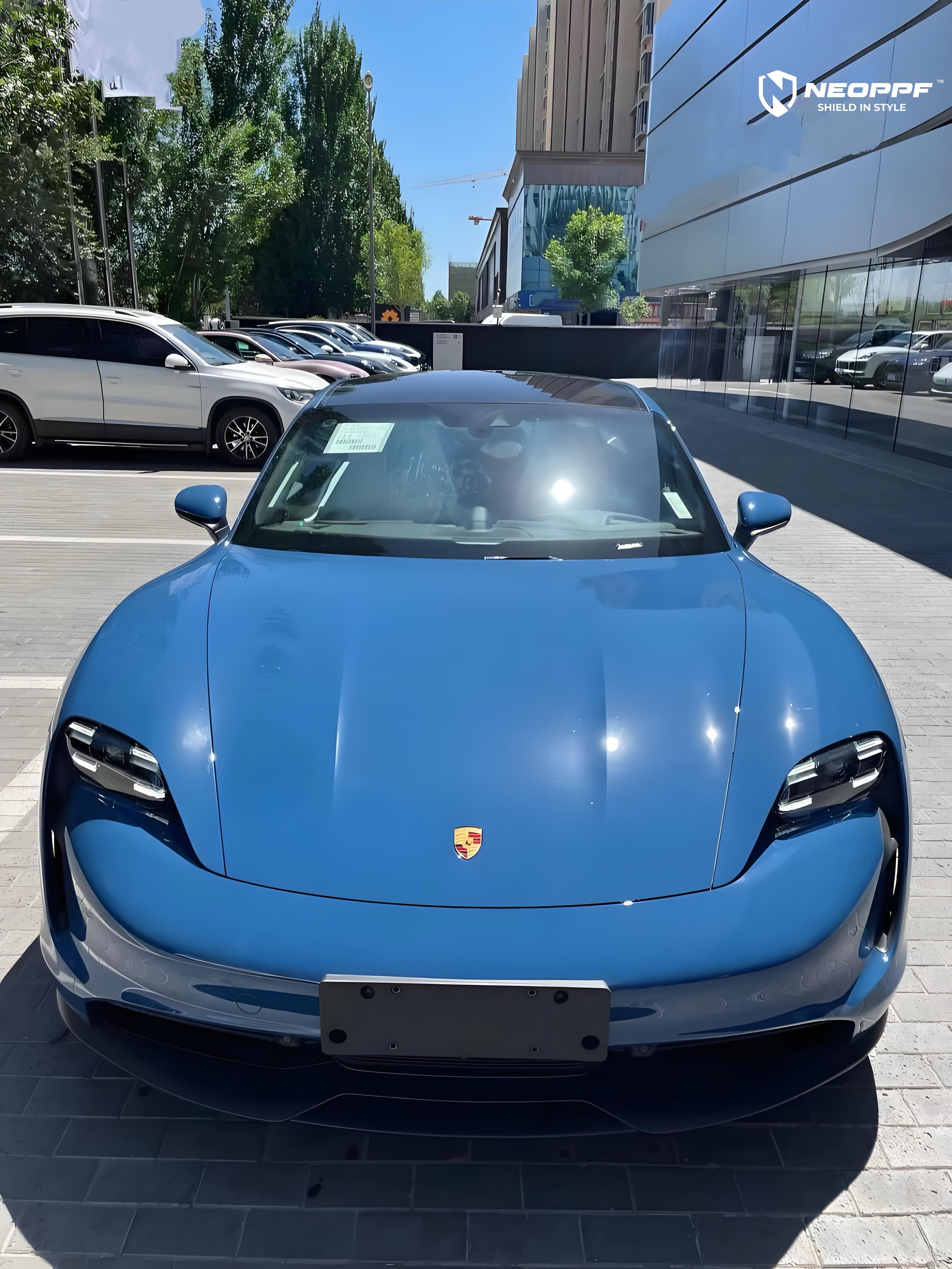 A sports car with Neptune Blue paint protection film colored wrap is parking in the garage