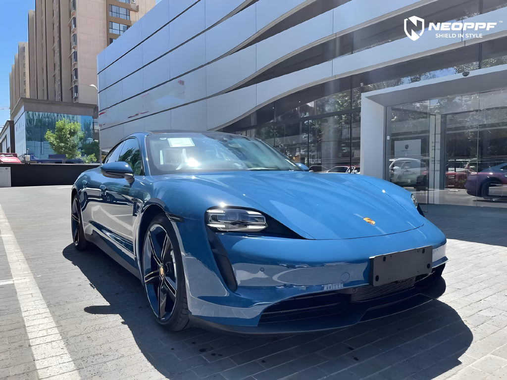 A sports car with Neptune Blue paint protection film colored wrap is parking in the garage