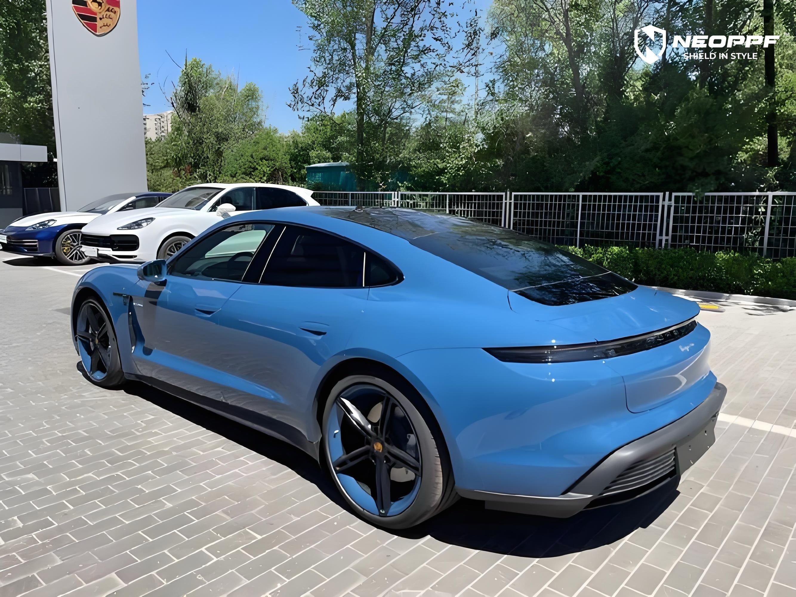 A sports car with Neptune Blue paint protection film colored wrap is parking in the garage