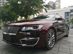 A sports car with Brocade Red paint protection film colored wrap is parking in the garage