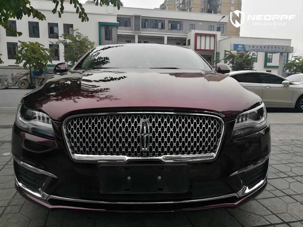 A sports car with Brocade Red paint protection film colored wrap is parking in the garage