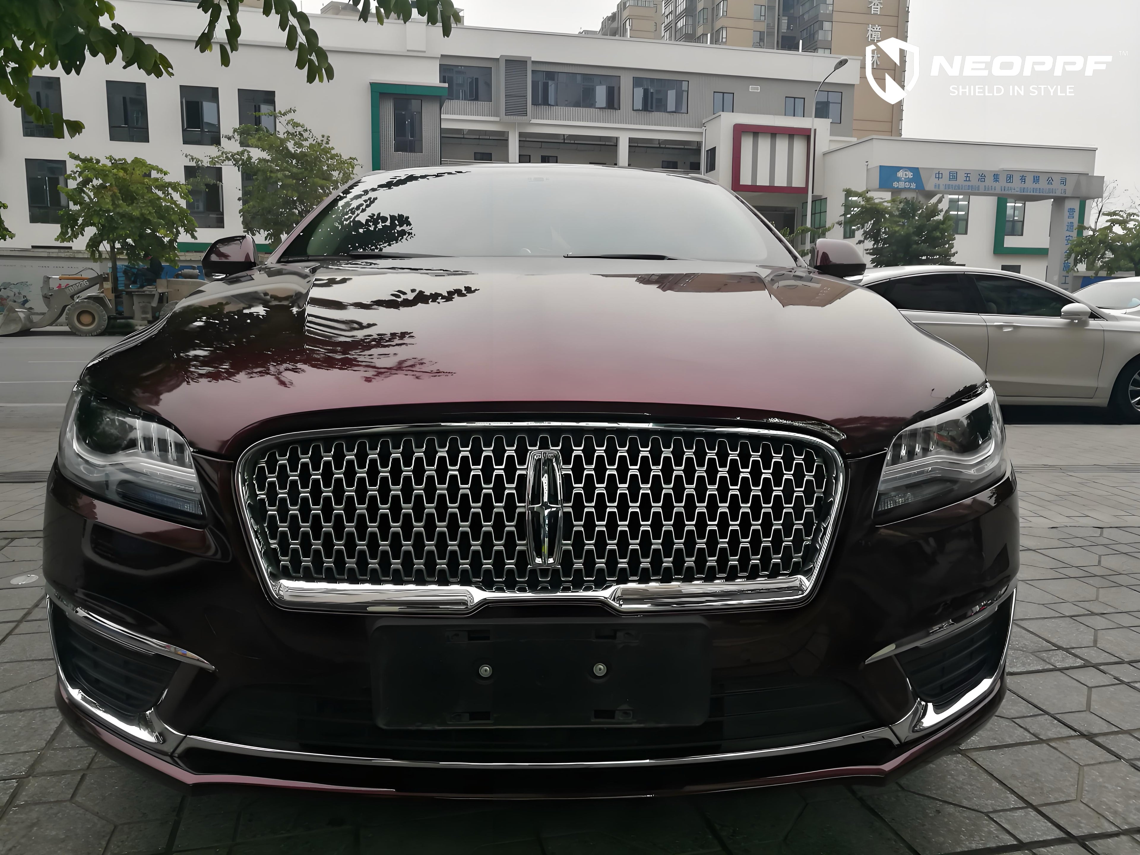 A sports car with Brocade Red paint protection film colored wrap is parking in the garage