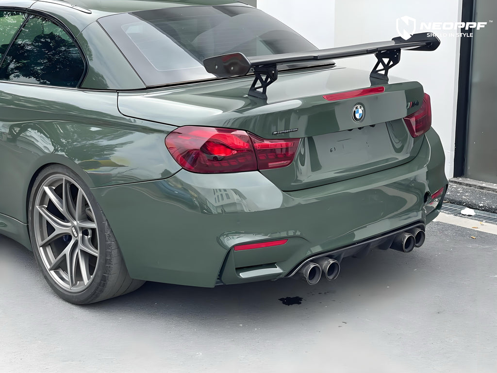 A sports car with British Green Metallic paint protection film colored wrap is parking in the garage