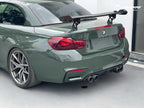 A sports car with British Green Metallic paint protection film colored wrap is parking in the garage