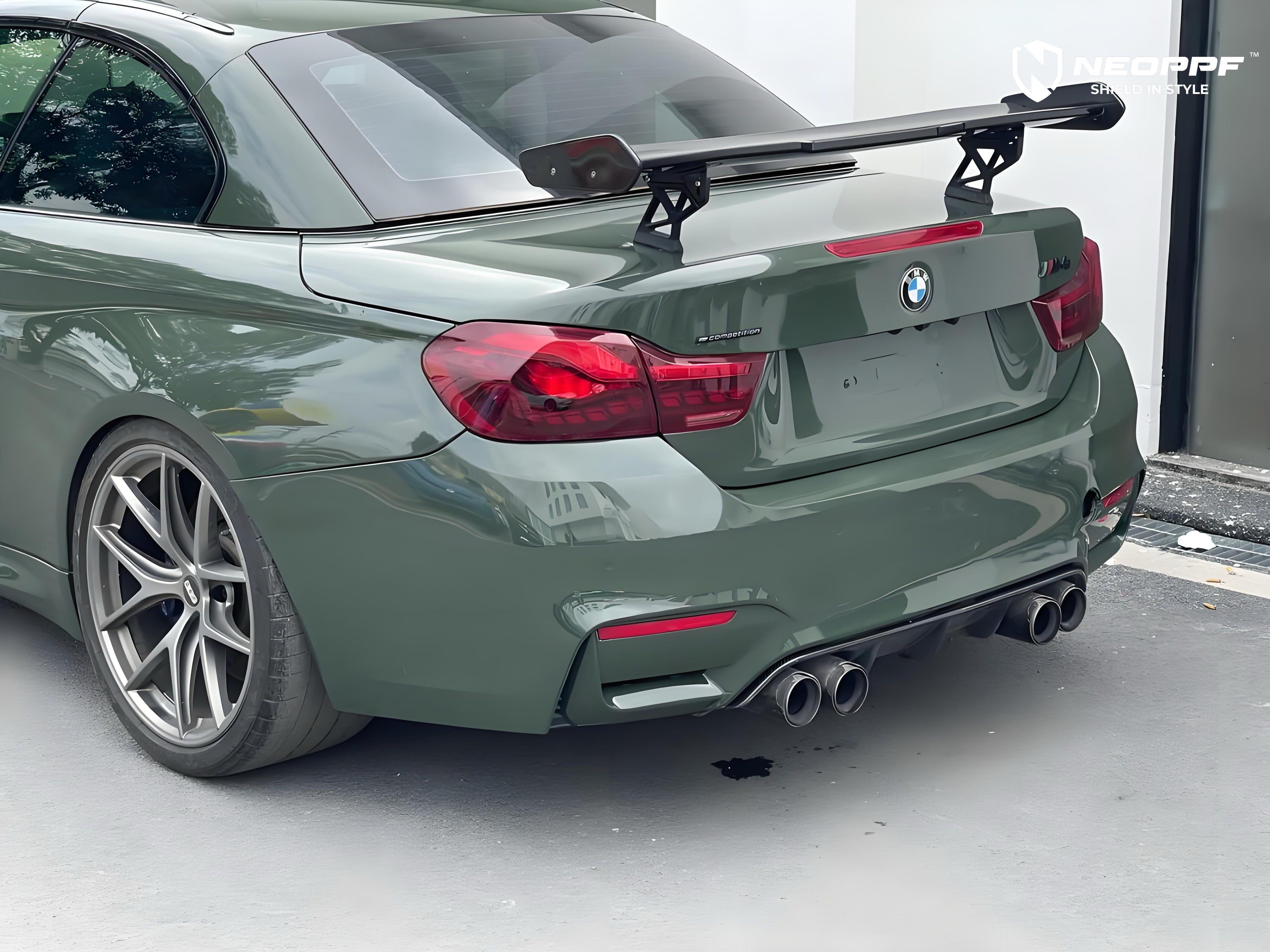 A sports car with British Green Metallic paint protection film colored wrap is parking in the garage