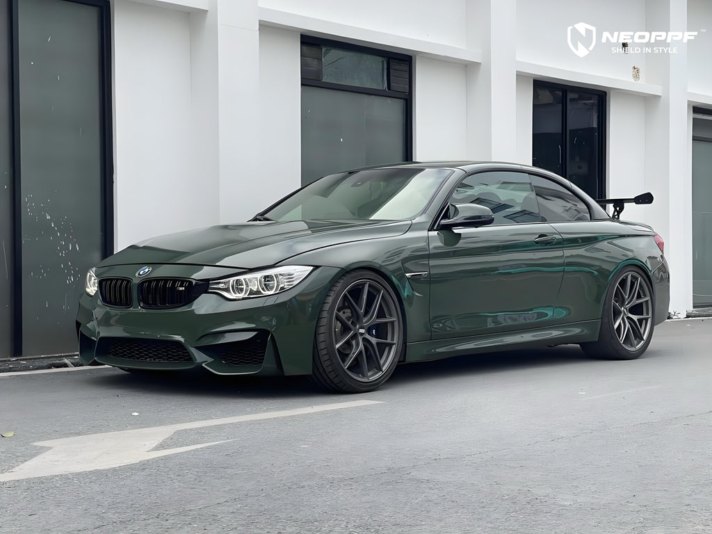 A sports car with British Green Metallic paint protection film colored wrap is parking in the garage