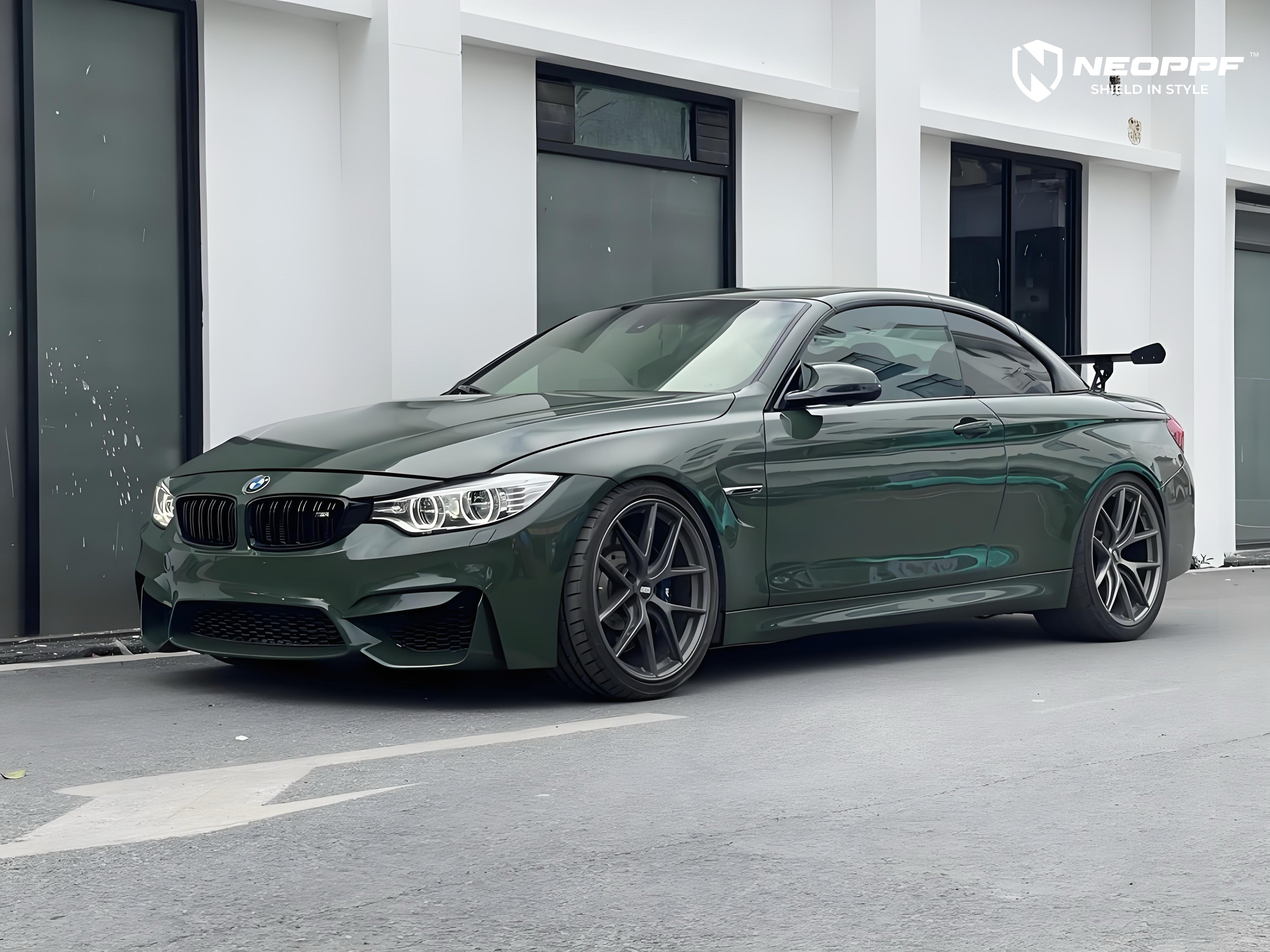 A sports car with British Green Metallic paint protection film colored wrap is parking in the garage