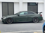 A sports car with British Green Metallic paint protection film colored wrap is parking in the garage